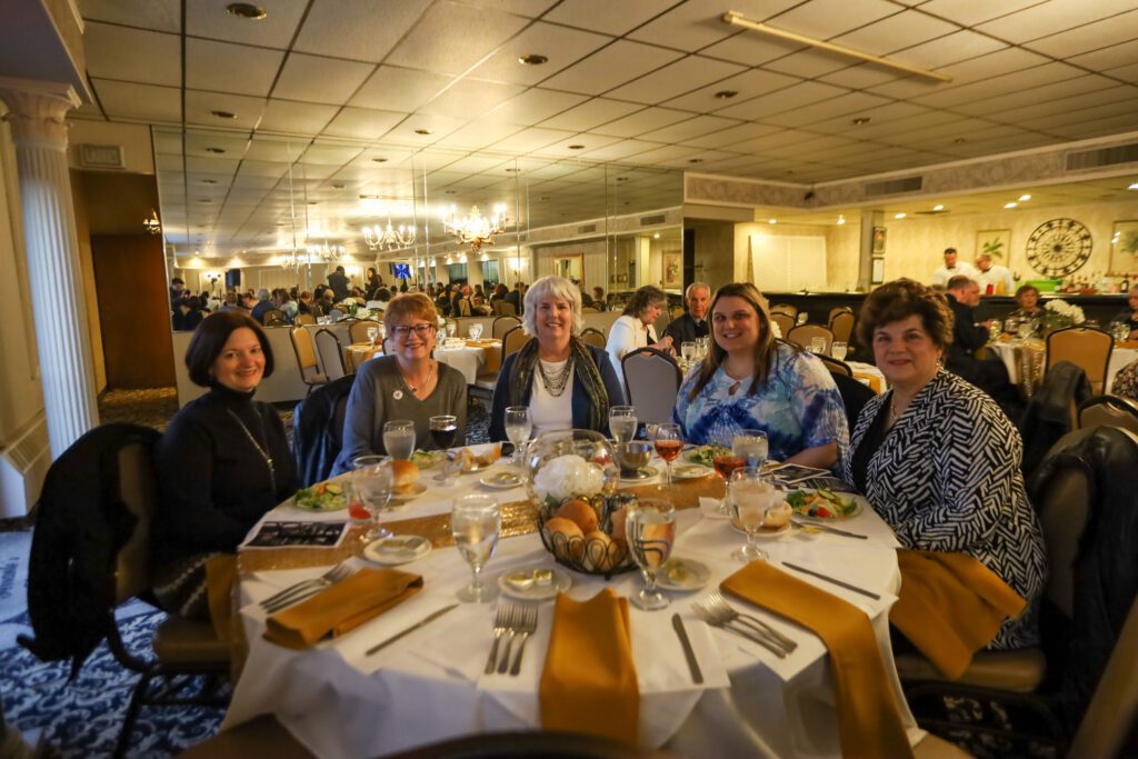 Smiling people sitting around a table at the fundraiser