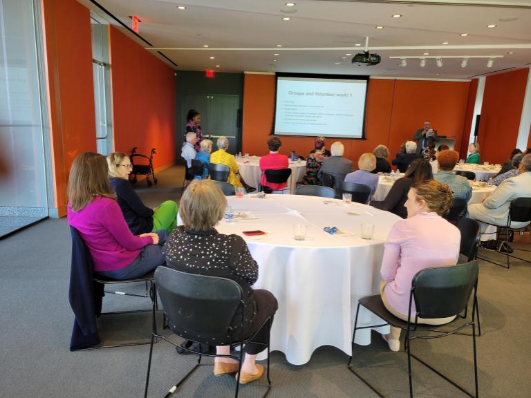 tables of people listening to presentation